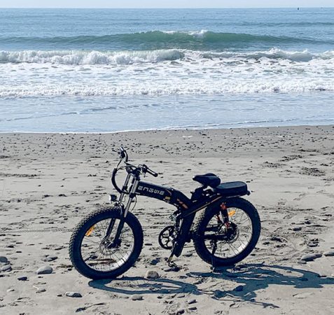 the engwe x24 fat tire electric bike resting on the beach