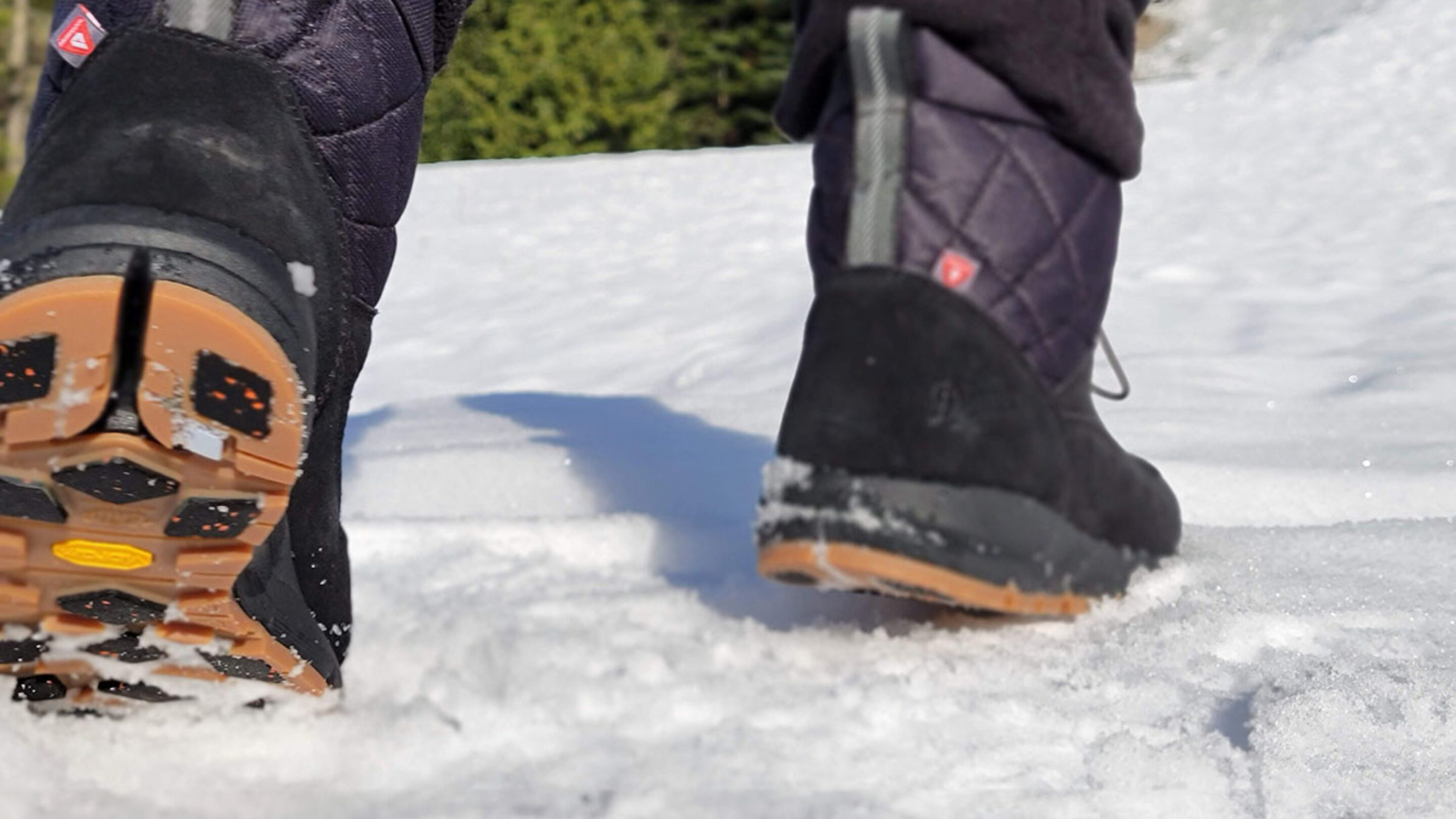 a shot of the vibram arctic grip outsoles on the danner cloud cap winter boots while walking in the snow