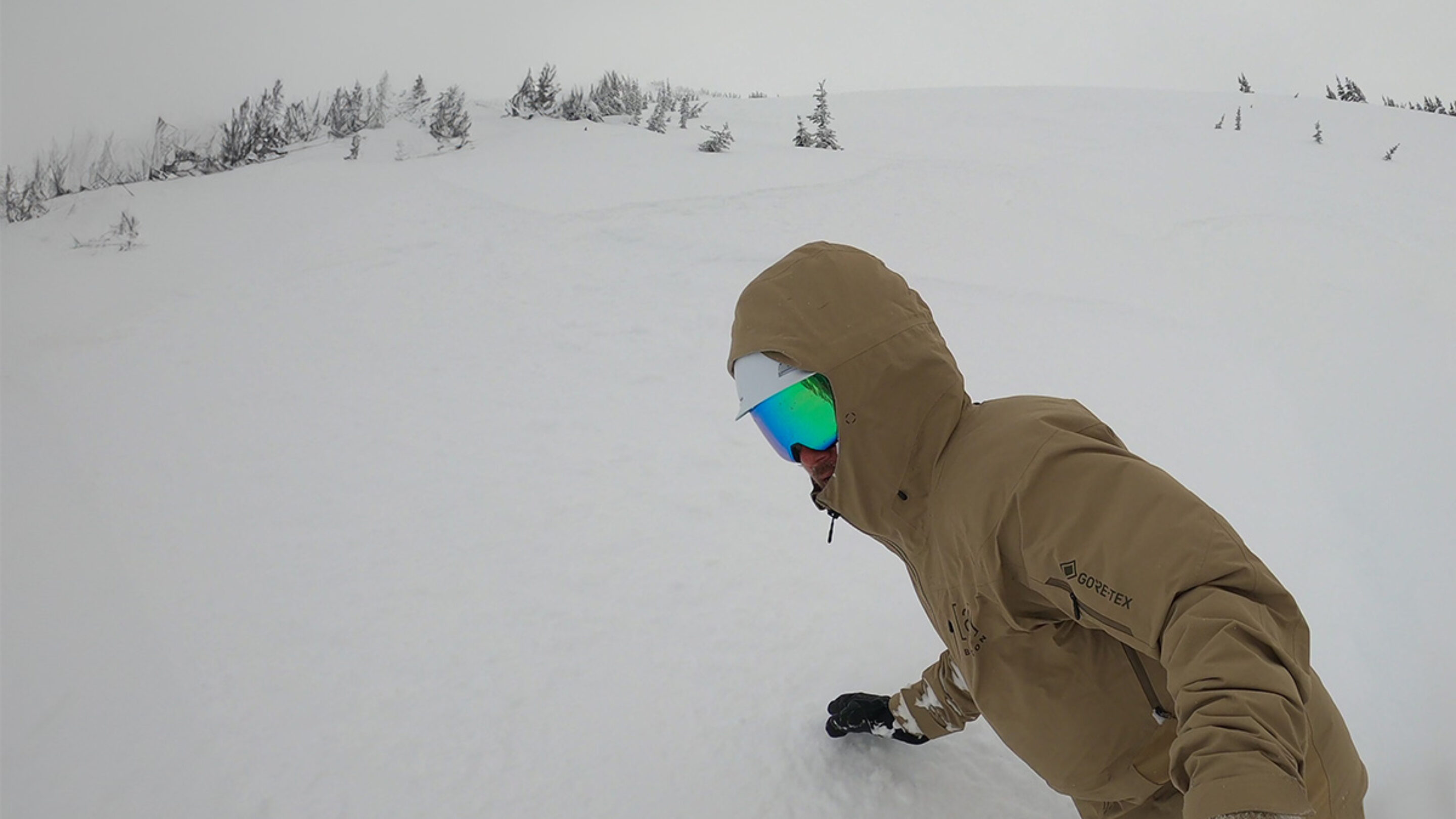 snowboarding in powder wearing the Smith 4D Mag goggles