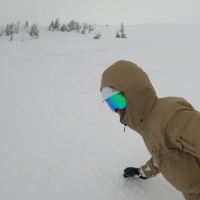 snowboarding in powder wearing the Smith 4D Mag goggles