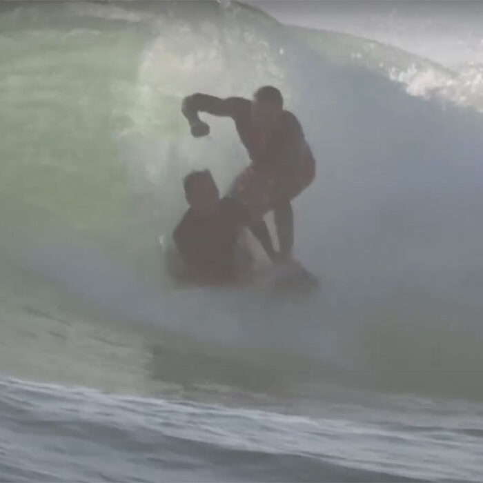 surfer punches boogie boarder