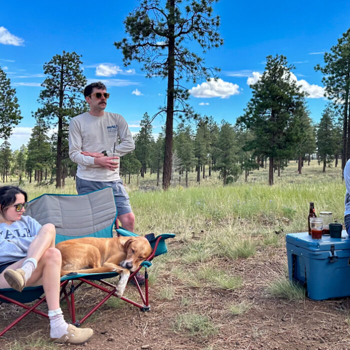 sitting in camping chair around site