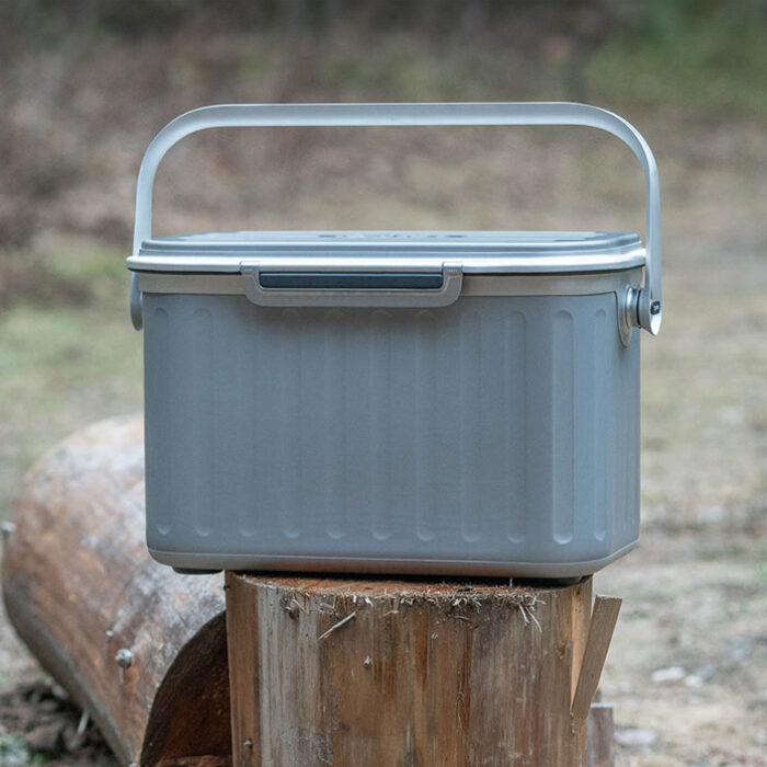 The Oyster Tempo cooler sitting on a log in the forest