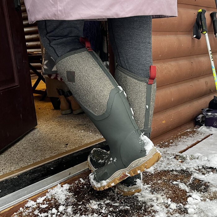 Muck Boot Women's Arctic Sport II Tall Boot walking into cabin