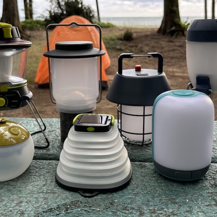a bunch of camping lanterns sitting on a table