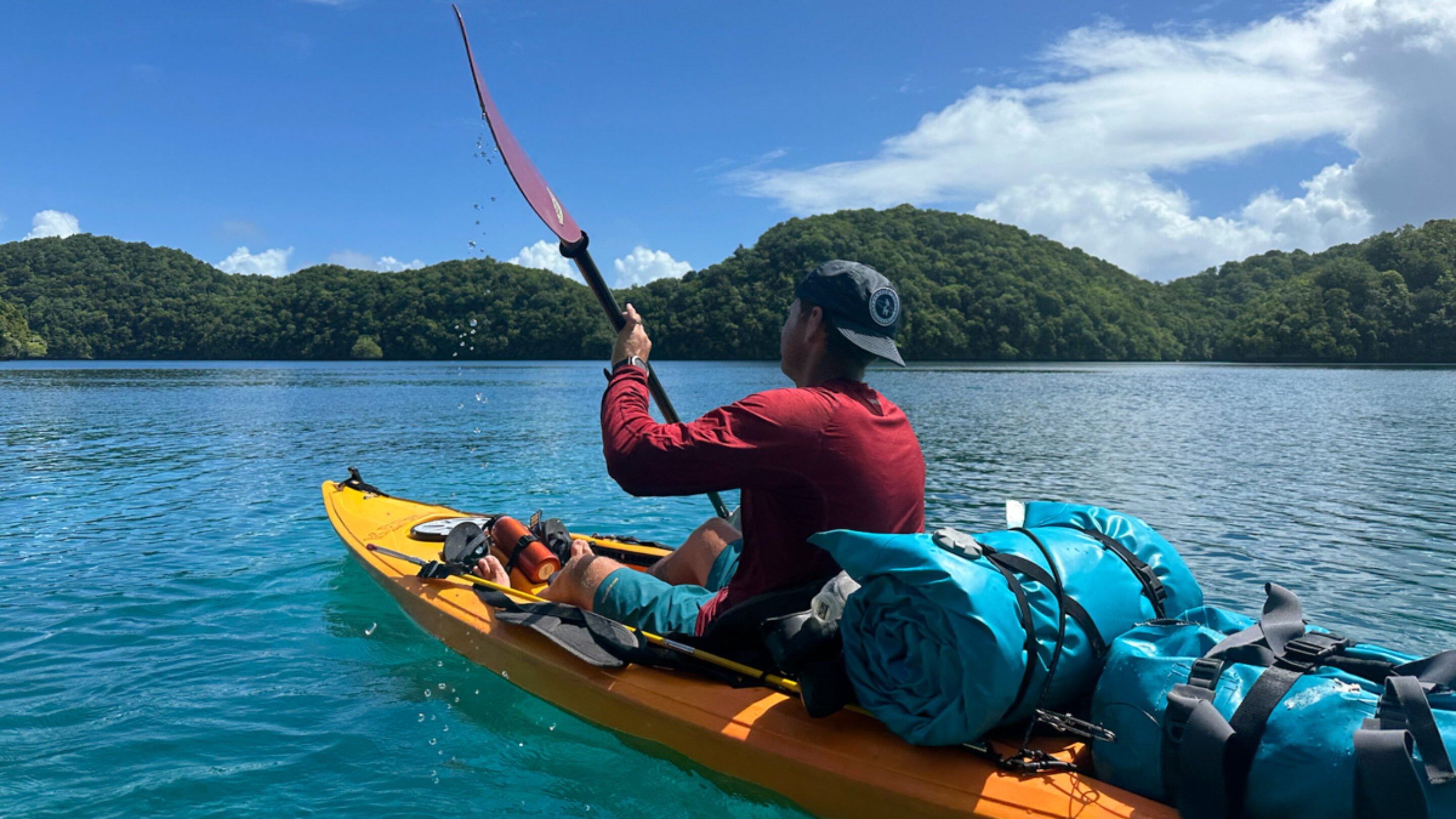 man kayaking in a sun shirt