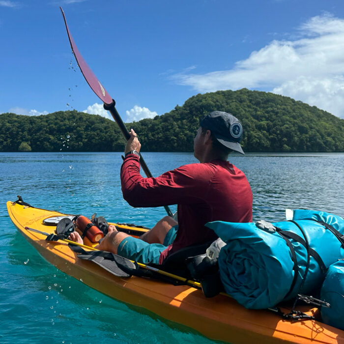 man kayaking in a sun shirt
