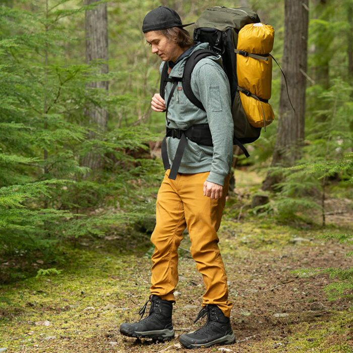 a hiker in the forest with the oboz bangtail mid winter hiking boots