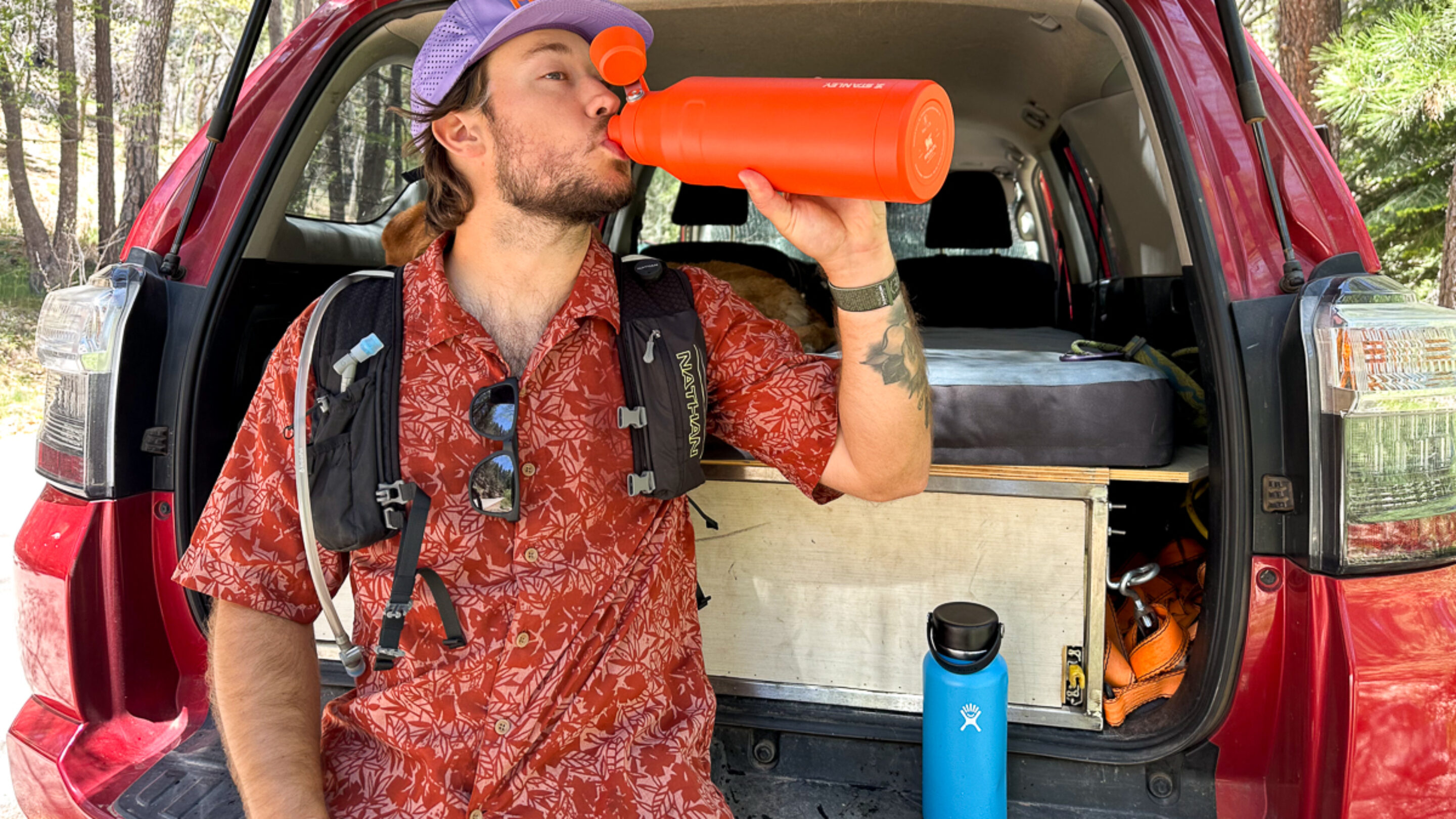 man drinking out of water bottle