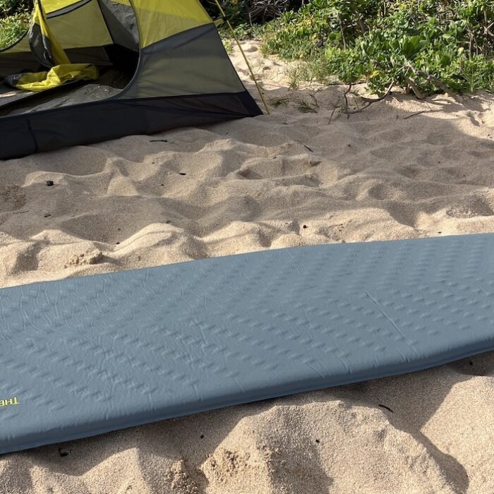 therm-a-rest sleeping pad on the sand in front of a tent