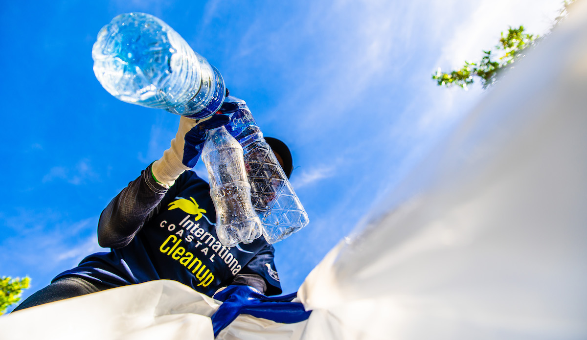 a man cleans up ocean plastic