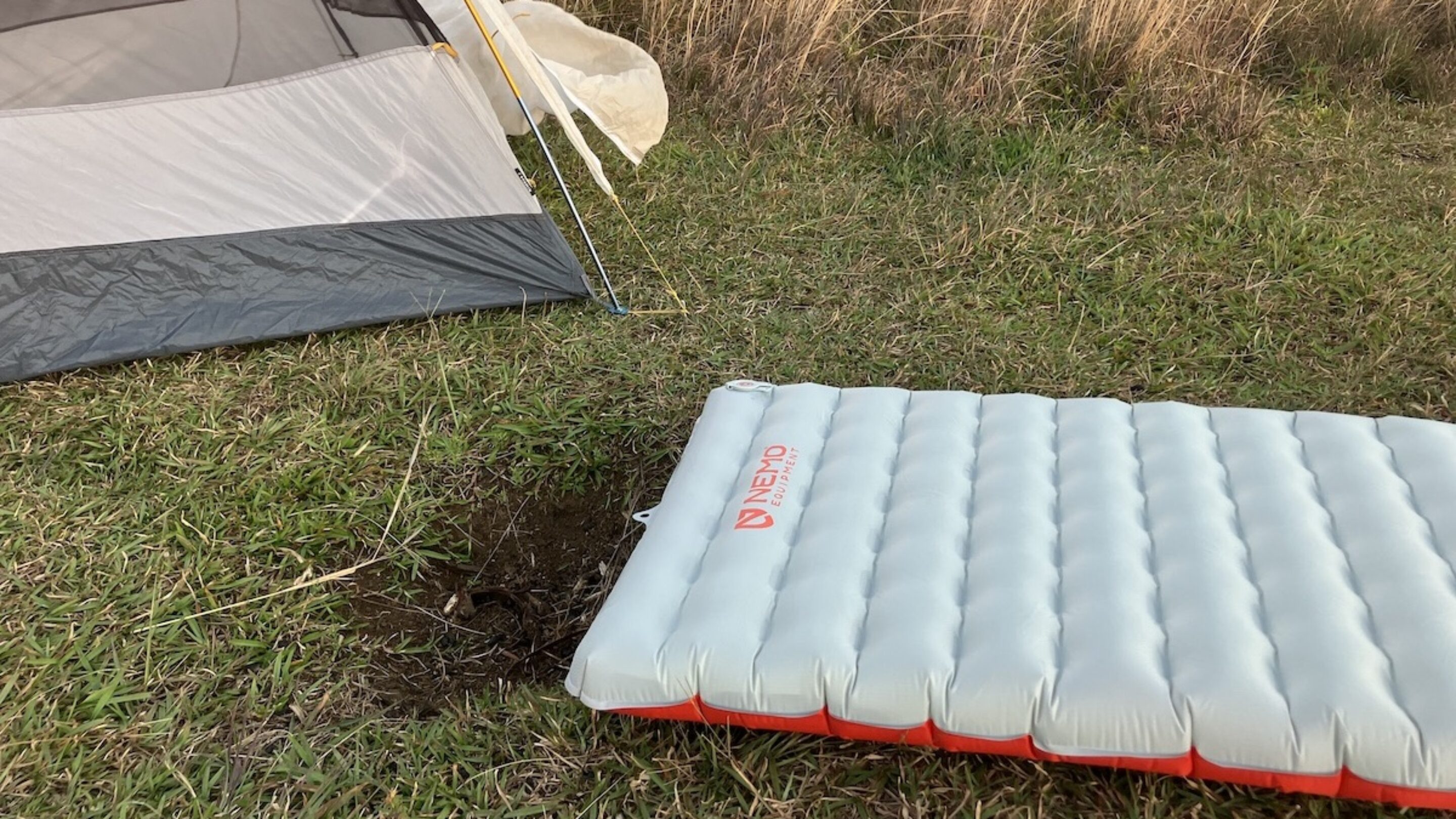 nemo tensor sleeping pad on the ground in front of a tent