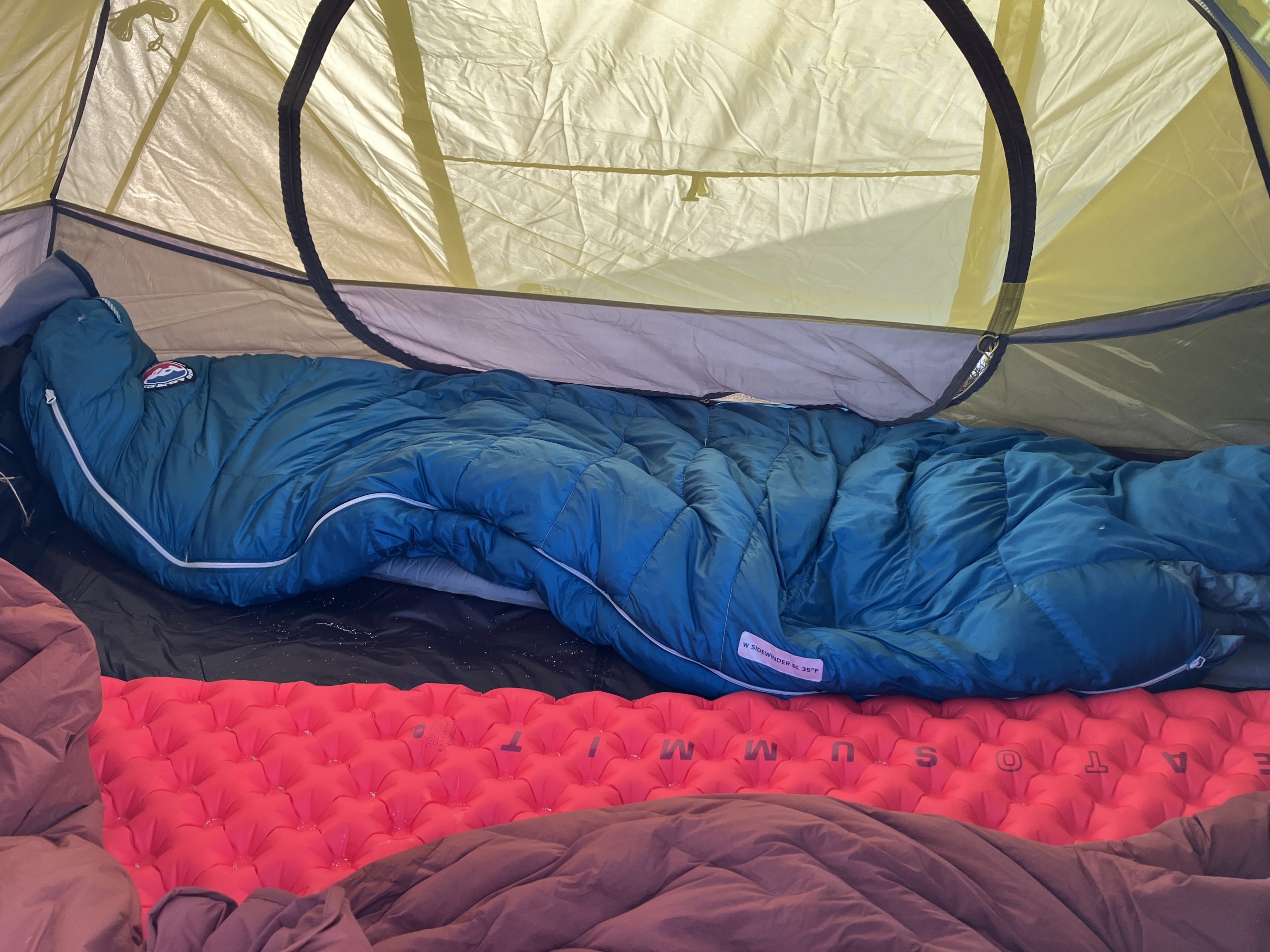 sleeping bags and sleeping pads in a tent