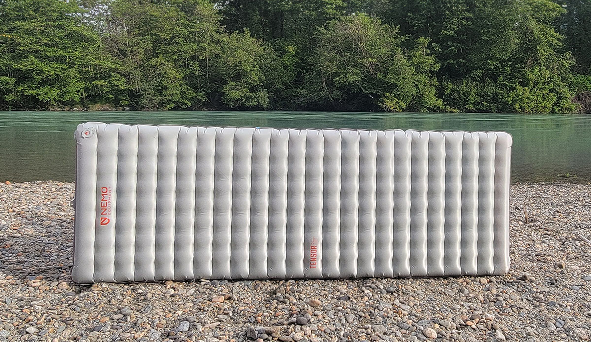 the tensor sleeping pad by nemo next to a river