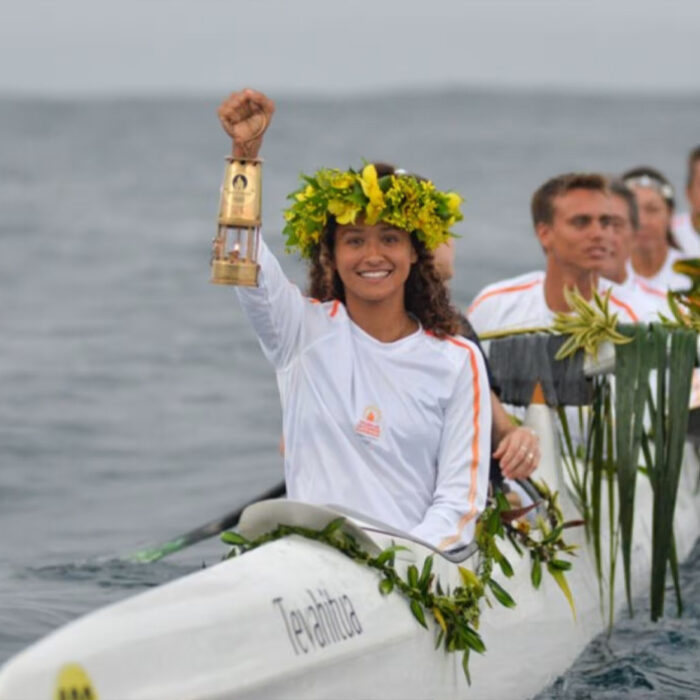 Tahitian surfer Vahine Fierro carrying the Olympic torch. Photo: Olympics.com