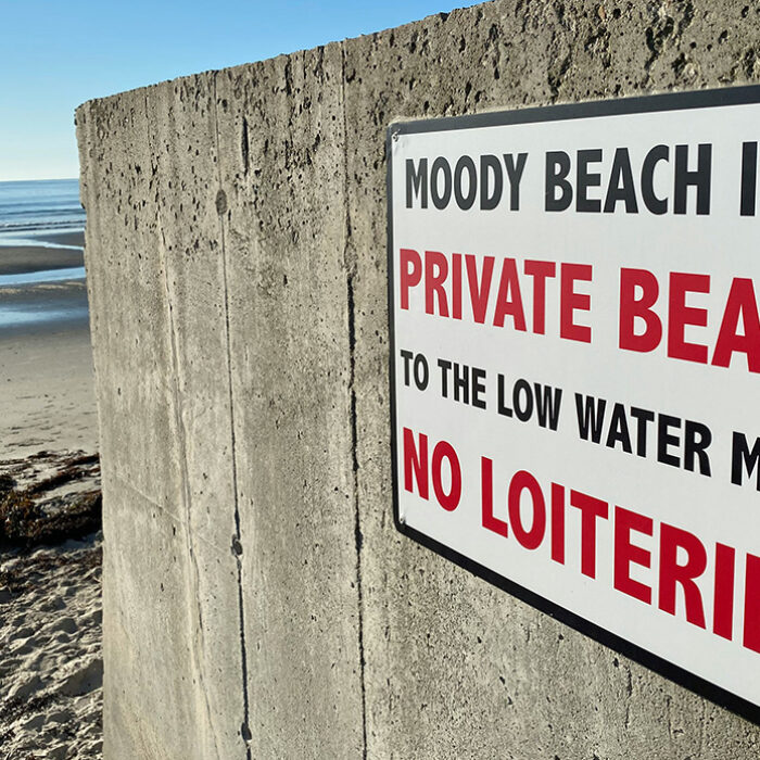 A sign warning the public away from Moody Beach in Wells, Maine. Photo: Jim Petkiewicz // Unsplash