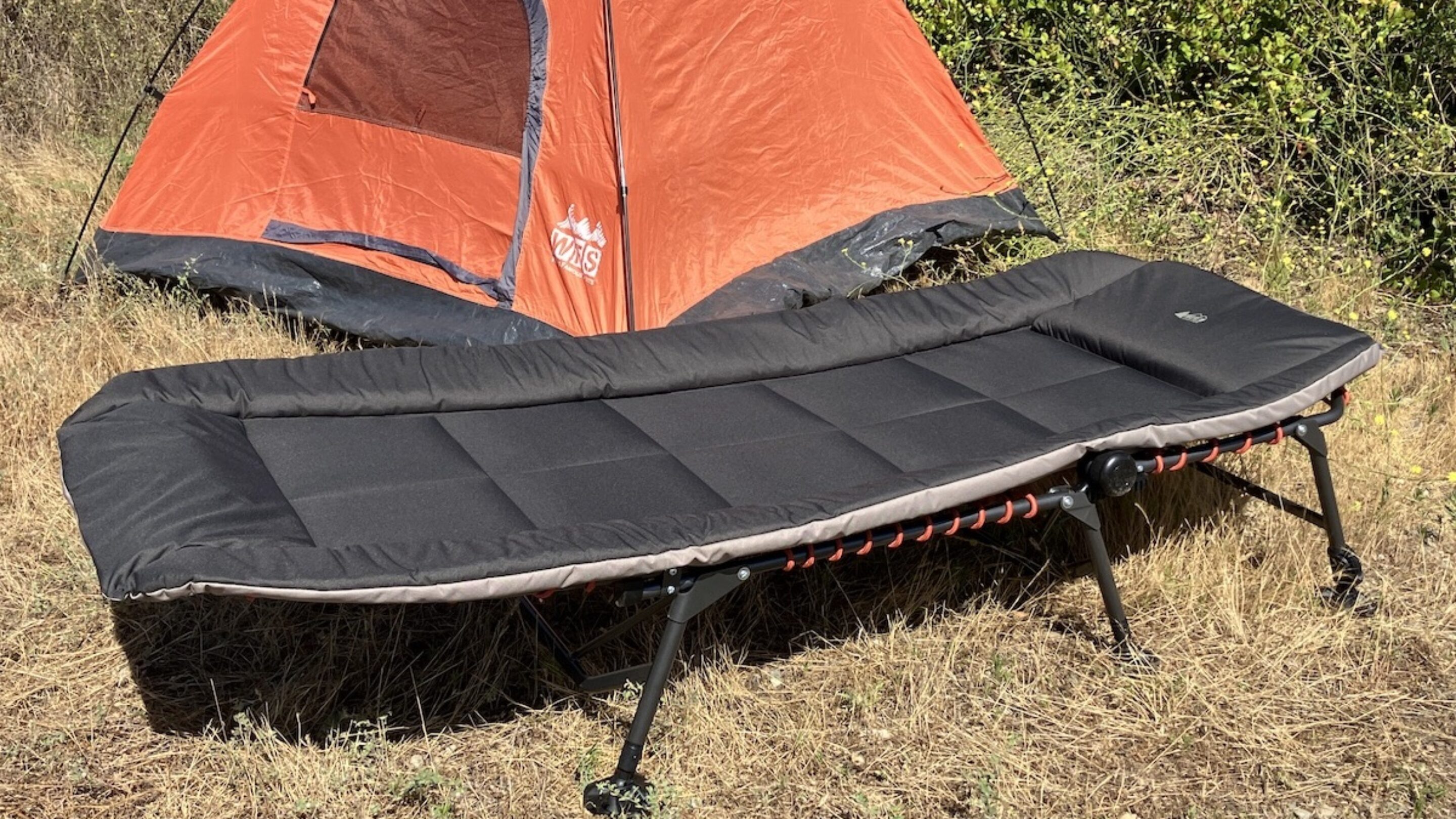 The REI Kingdom Cot in front of a tent
