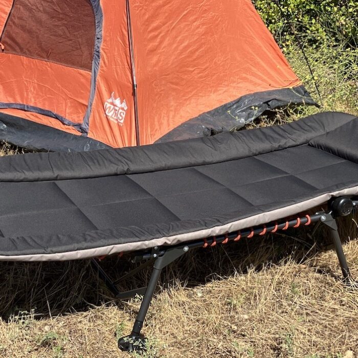 The REI Kingdom Cot in front of a tent