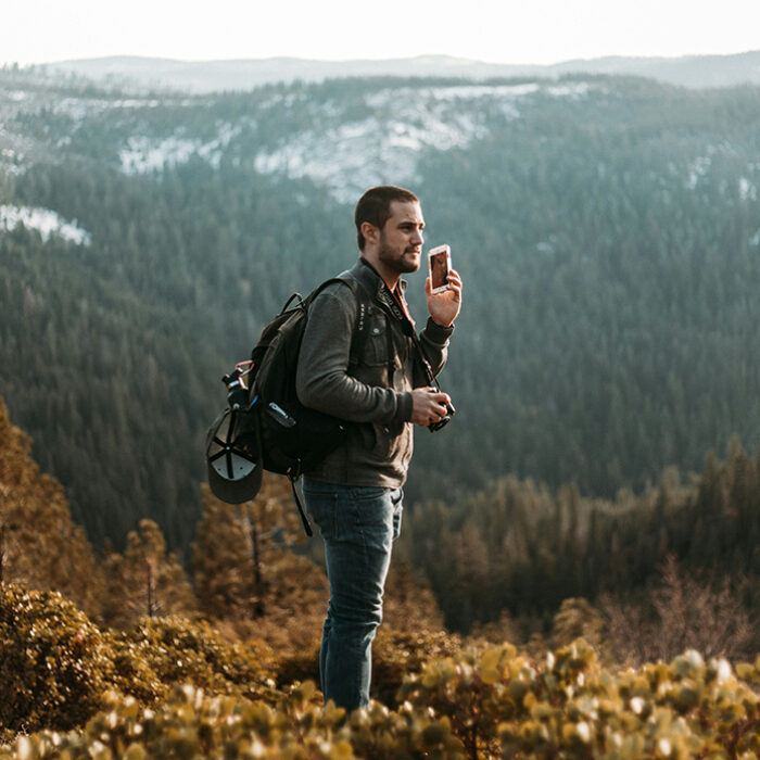 Smartphones have revolutionized the way we hike. They’ve given us access to useful apps that provide maps, trails, weather, and, more recently, emergency communication outside of cell signal range. Back in January I openly posed the question if Apple’s SOS emergency satellite messaging feature on iPhone 14 and 15 could replace the long-trusted satellite devices specifically built for those who recreate outdoors. The conclusion that I reached was: not just yet. While useful, feedback on Apple’s satellite feature indicated that it wasn’t as reliable as dedicated satellite communication devices like Garmin, and the smartphones themselves aren’t as durable in the elements. However, I also curiously ended my story with this sentence: “I can’t imagine it will take too long for Apple to improve its satellite capabilities to more strongly compete in the market.” With the latest software update, iOS 18, which will be released in the fall, Apple is building on its satellite communication service. Now, instead of only emergency calls via satellite, you’ll be able to freely communicate via iMessage or SMS with whomever you please on iPhone 14 or newer. Want to message your friends while camping out of cell range? No problem. It may seem like a minor update, but it’s another smartphone incursion into the satellite device space. Even Android is experimenting with it too. Grayson Haver Currin penned a piece for Outside that gave a great example of how this service would have saved him some trouble. Currin got separated from his wife on the Continental Divide Trail. Unable to directly contact her, he used his iPhone satellite feature to contact emergency services and get search and rescue involved. Had he instead been able to contact her to request her location, the crisis would have been quickly averted. The satellite messaging service will only be available in the US, which is a tick on the “cons” side of the Venn diagram for those who live elsewhere. But, again, the point is that the service is improving fast. Apple is making its product increasingly tantalizing for outdoorsy people. As a hiker, I am tempted to pick up a new iPhone just for this update. Satellite messaging is not Apple’s only foray into the space currently dominated by outdoors-oriented technology companies. The iOS 18 update will also replicate features found in popular hiking apps, like AllTrails, in Apple’s own Maps app. As a thrifty, avid hiker, it’s hard to complain about the technology race. These desired features are becoming more accessible and at lower price points, which, in theory, should translate to safer hiking.