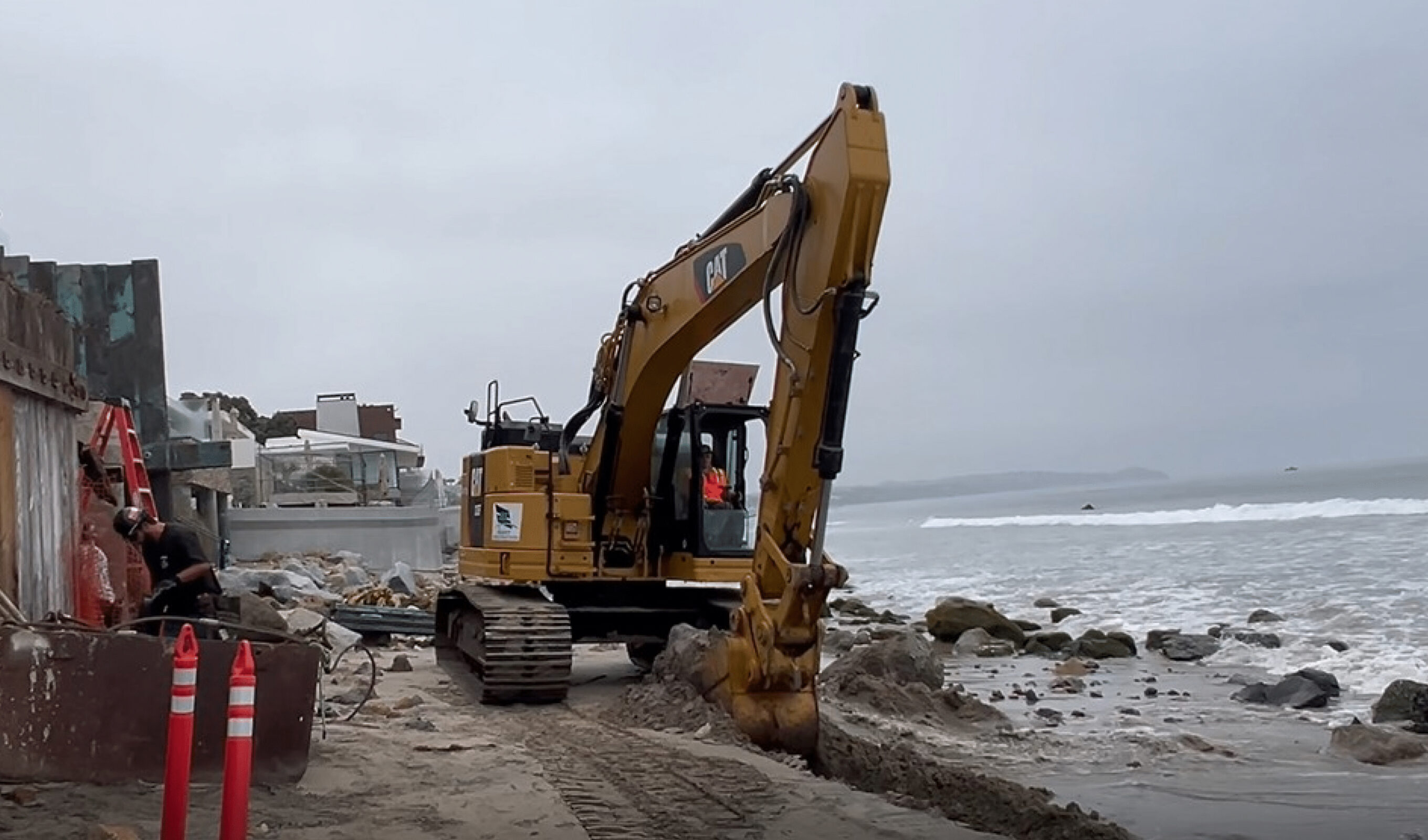 A photo from the filed complaint, allegedly showing an excavator removing sand from Malibu's Broad Beach for use in private construction. Photo: Court Documents