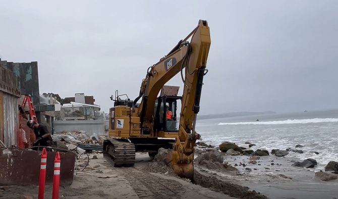 A photo from the filed complaint, allegedly showing an excavator removing sand from Malibu's Broad Beach for use in private construction. Photo: Court Documents