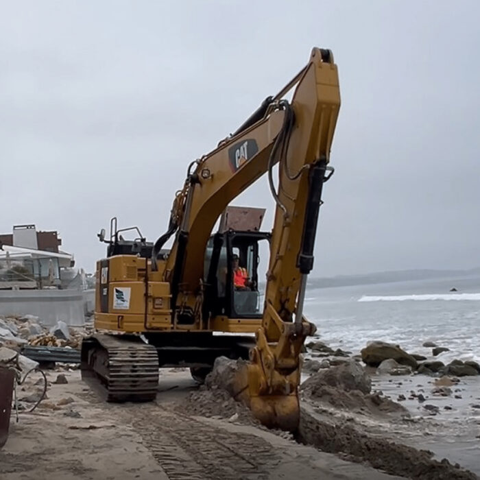 A photo from the filed complaint, allegedly showing an excavator removing sand from Malibu's Broad Beach for use in private construction. Photo: Court Documents
