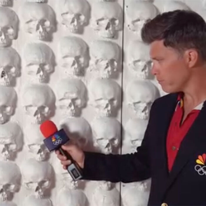 Colin Jost interviewing wall of skulls