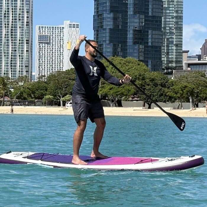 a man paddling an inflatable paddle board
