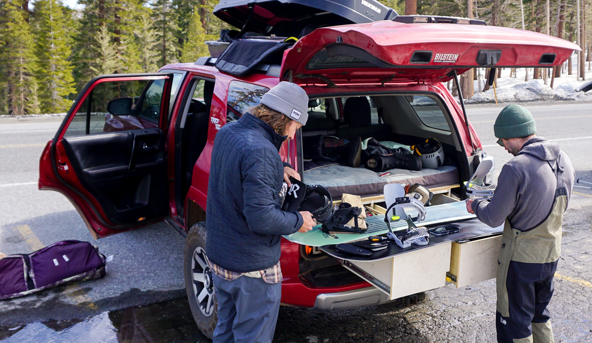 setting up snowboards near snowboard bag