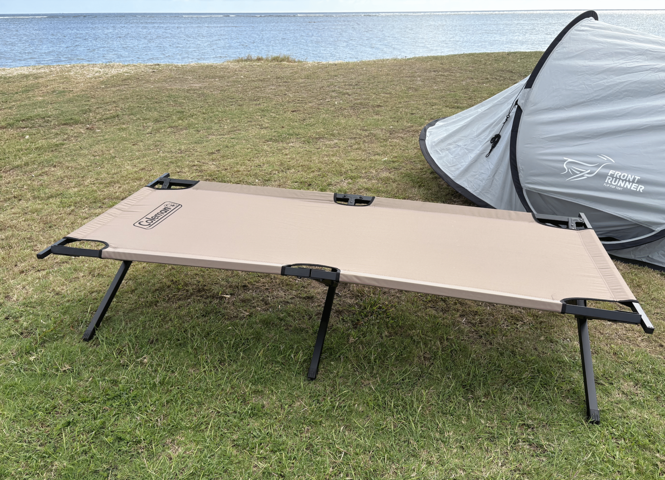 a camping cot in front of a tent