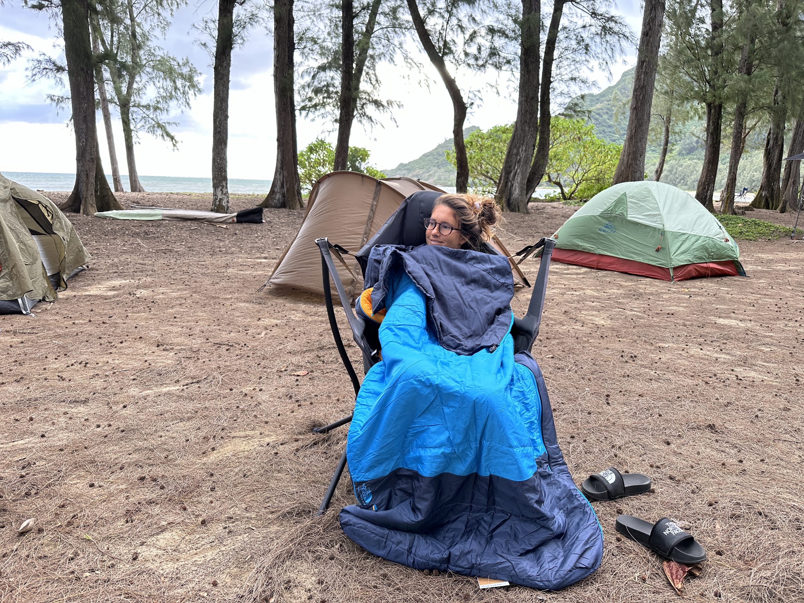 a woman sitting in a Stargaze chair in a sleeping bag
