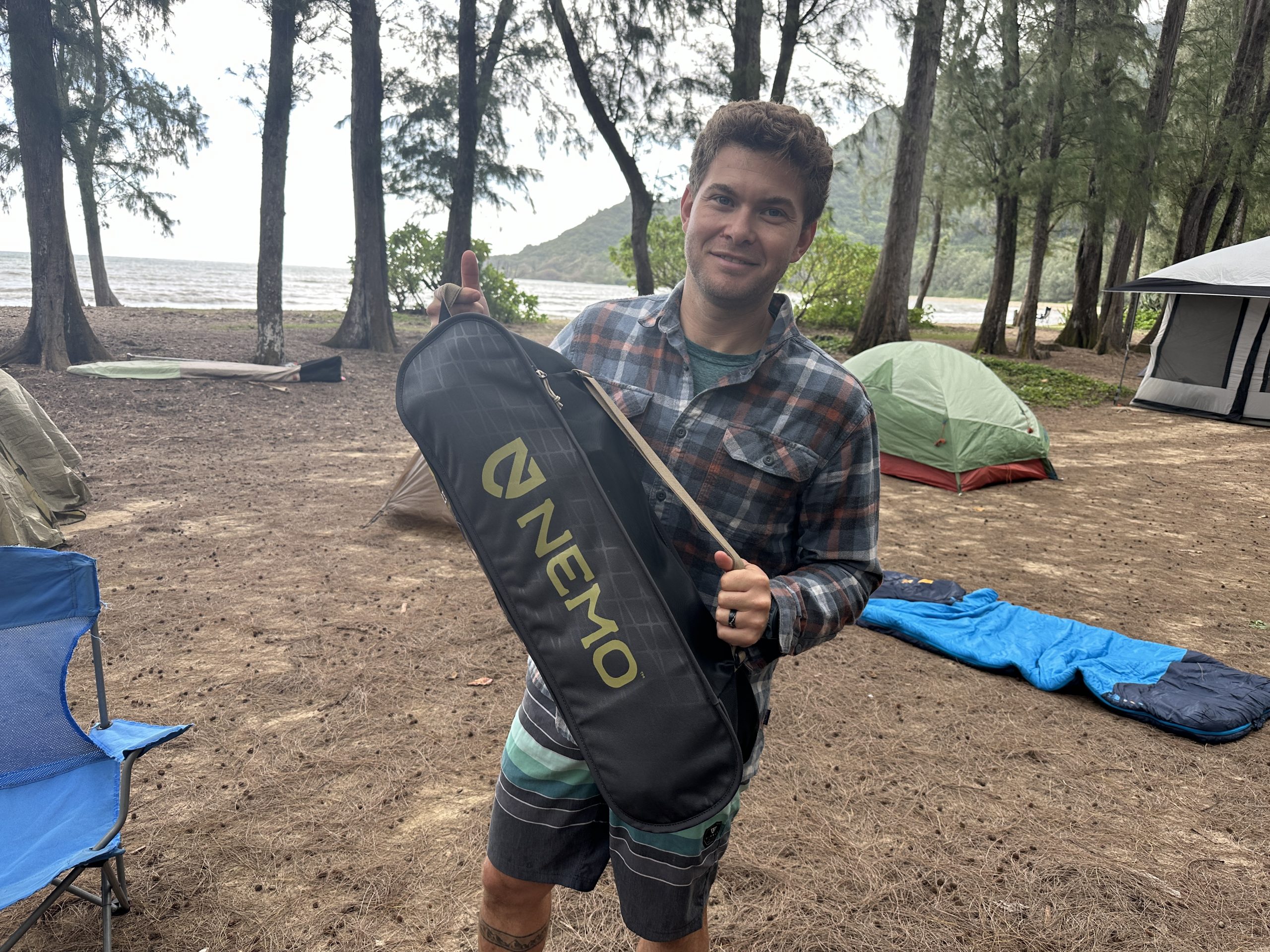a man holding a Nemo Stargaze packed up