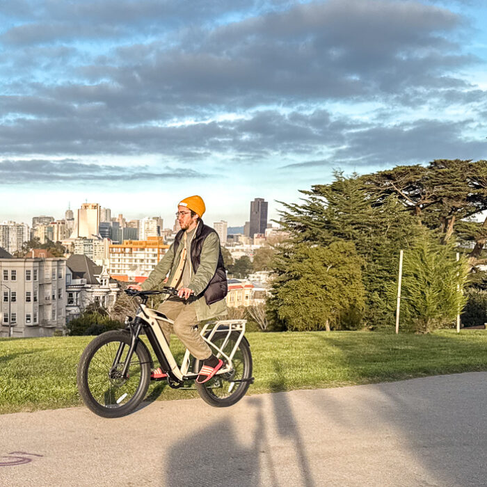 man riding ebike through park