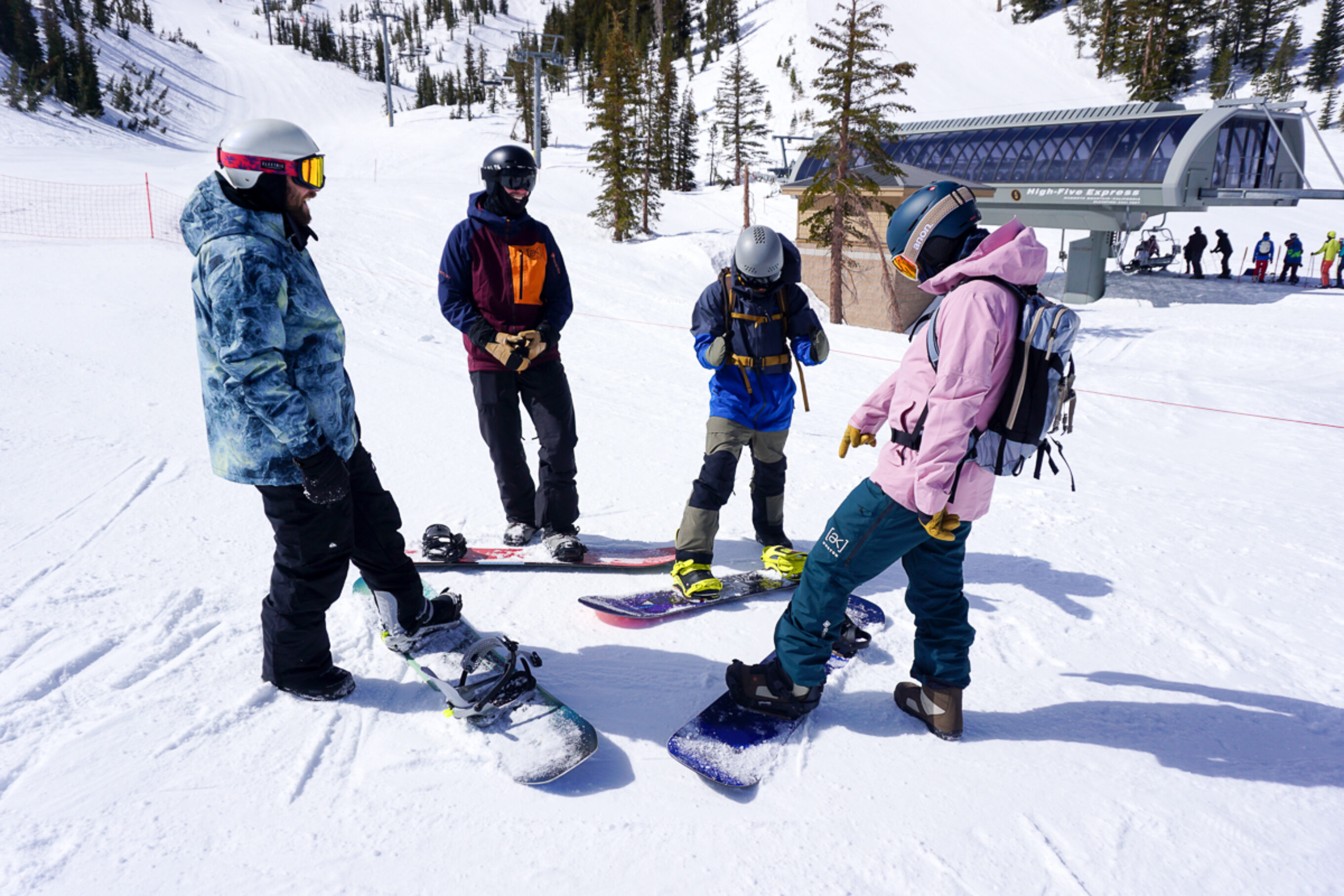 snowboarders standing around 