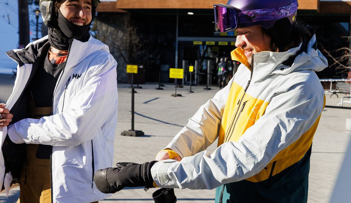 man pulling on snowboard mittens