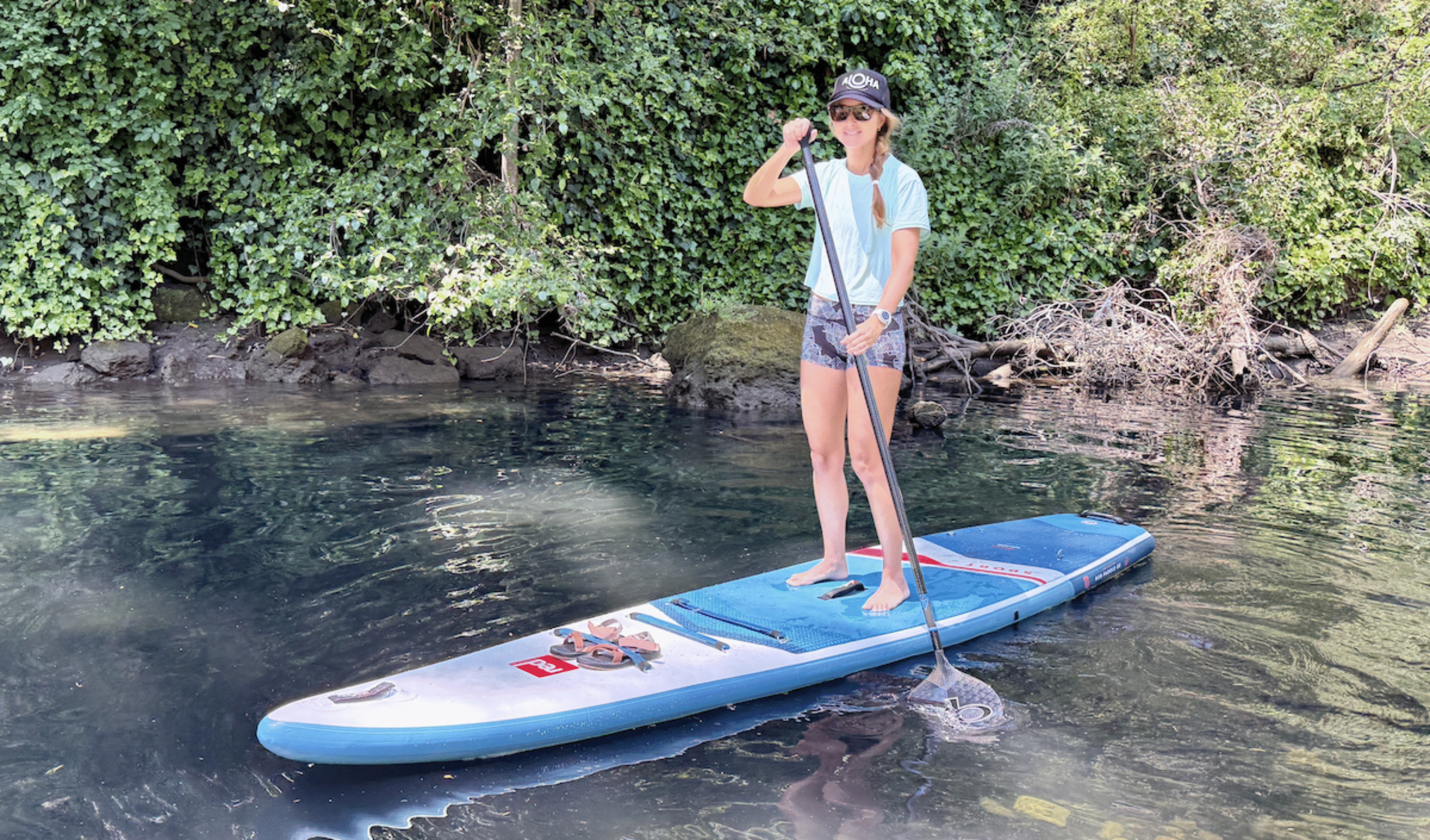 a woman paddling a sup on a river
