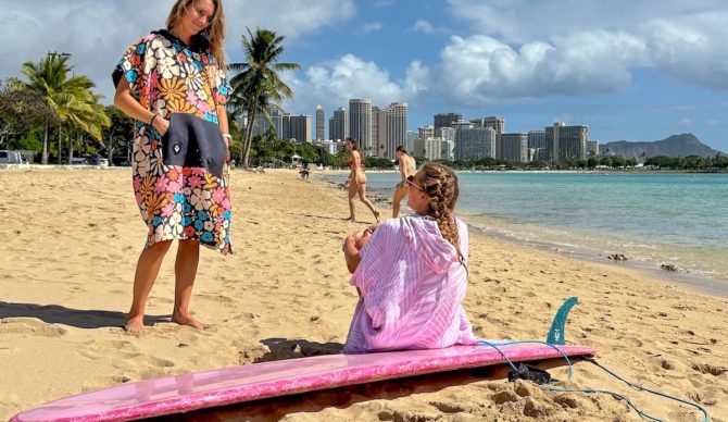 women wearing surf ponchos at the beach