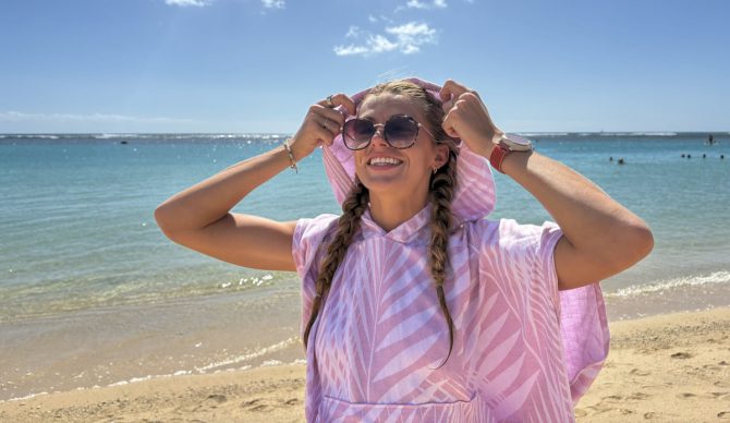 putting on a surf poncho hood