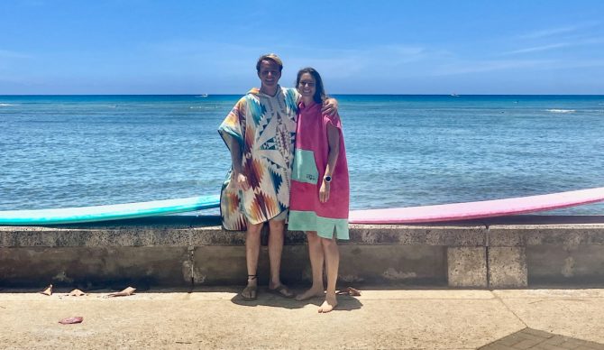 wearing surf ponchos by the water