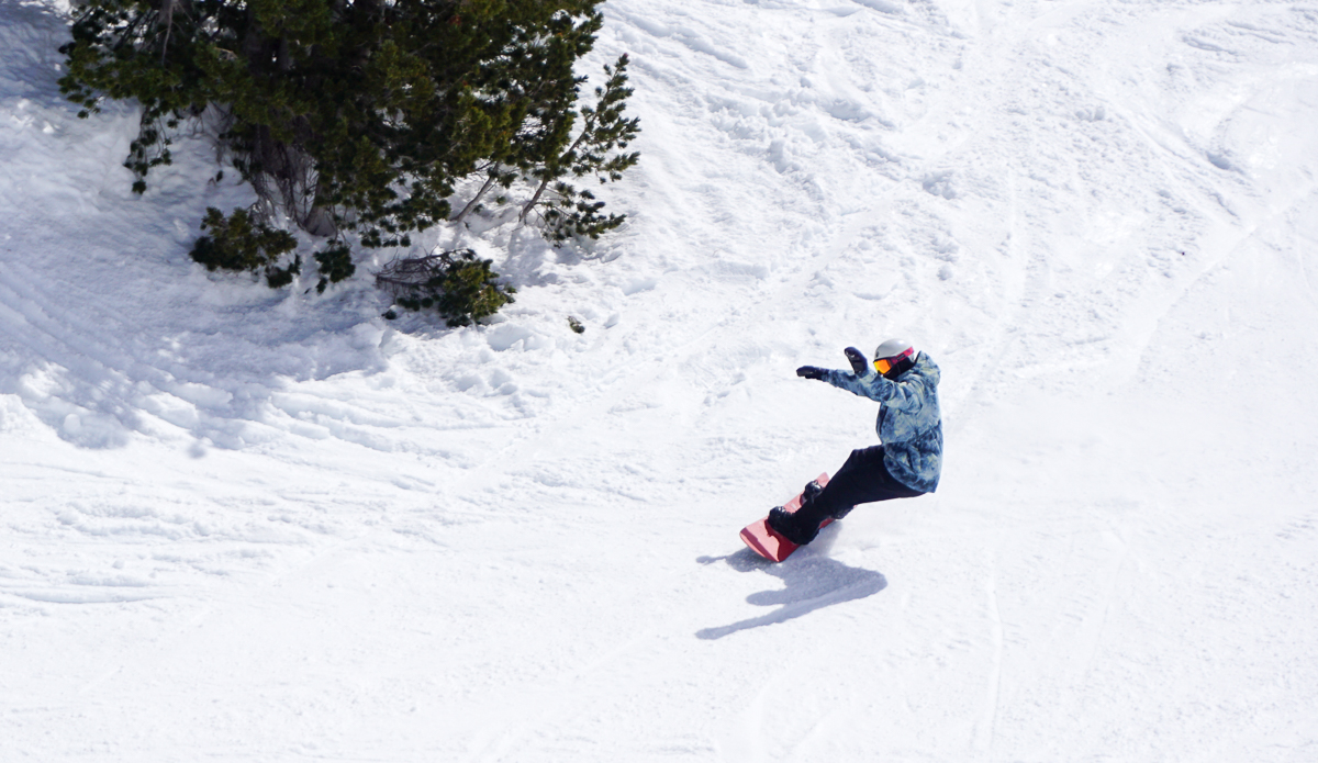 man carving on snowboard