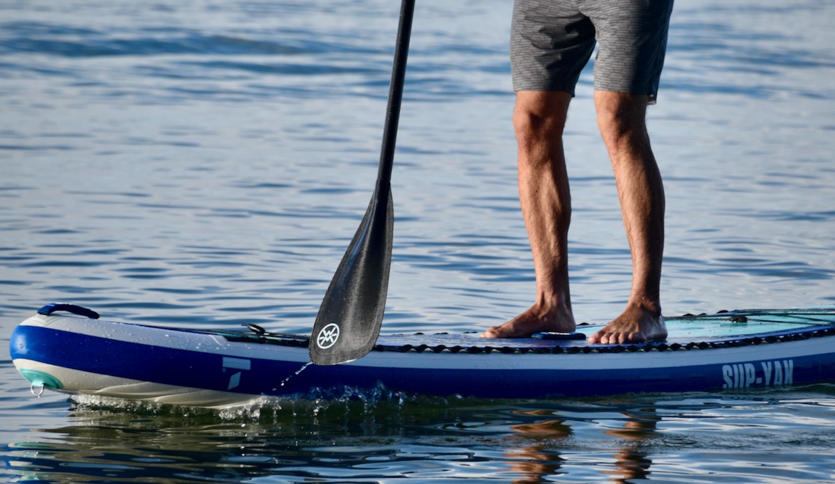 a man paddle boarding on Lake Tahoe with the Werner Trance 95 paddle