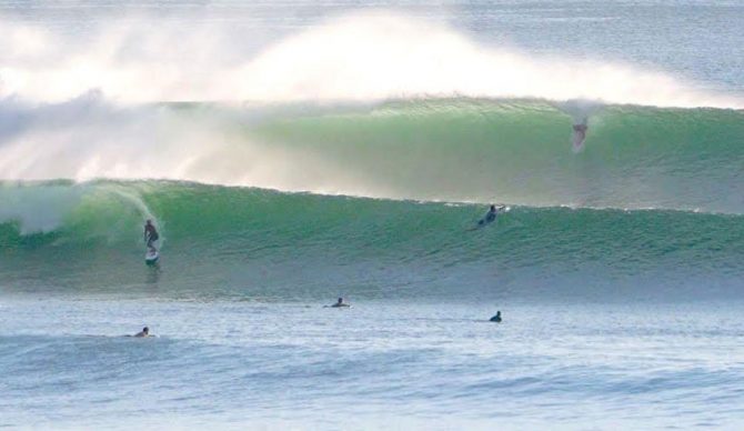Surfers riding Impossibles on the Bukit Peninsula