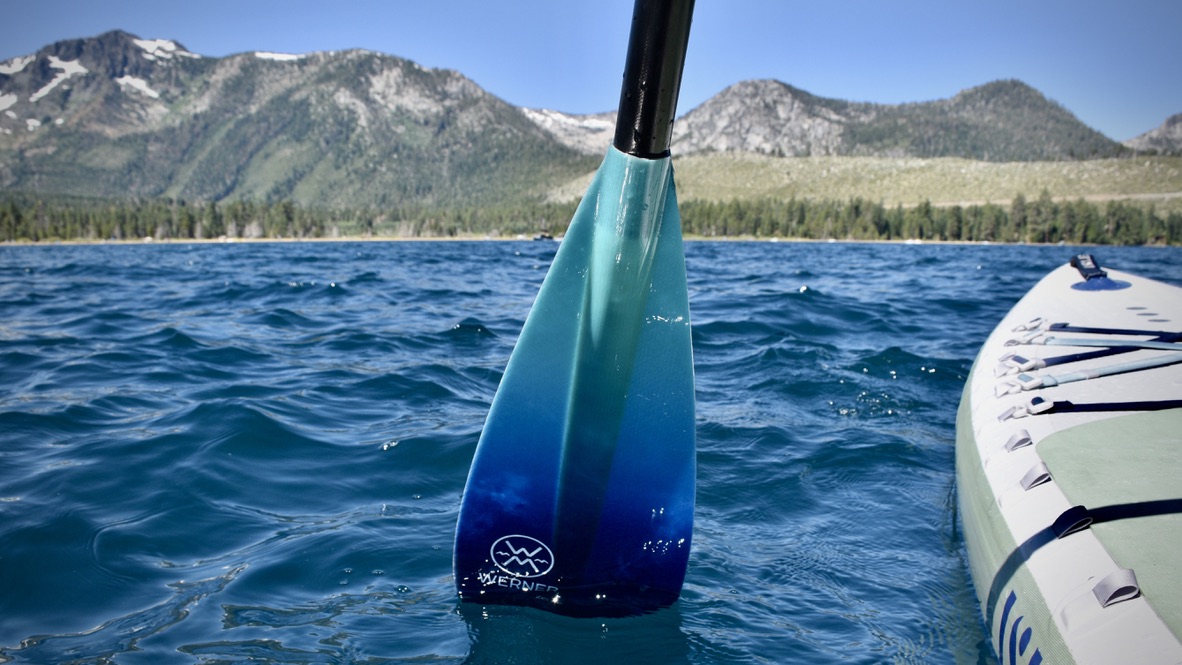The Werner Zen 95 SUP paddle in action on Lake Tahoe with mountains in the background.
