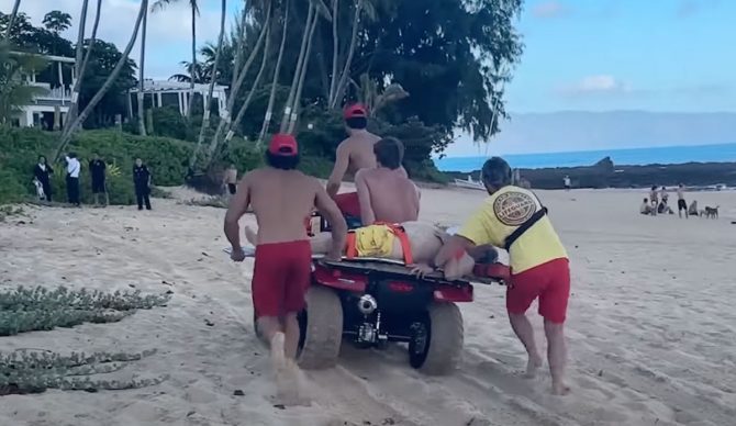 Lifeguards taking drowning victim to hospital from Ke Iki beach