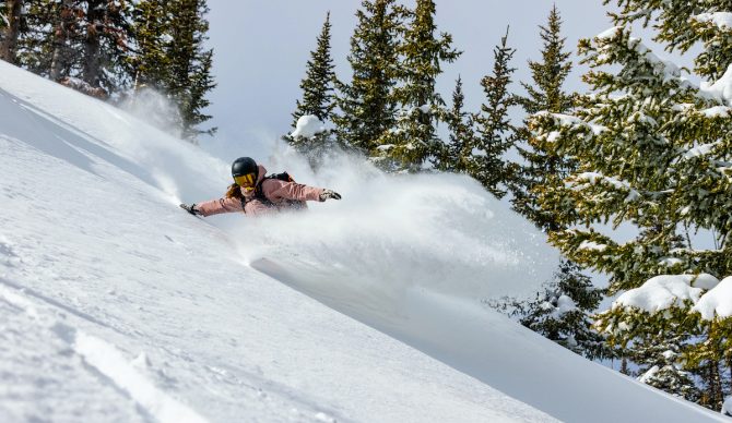 A woman rips powder snow after an atmospheric river.