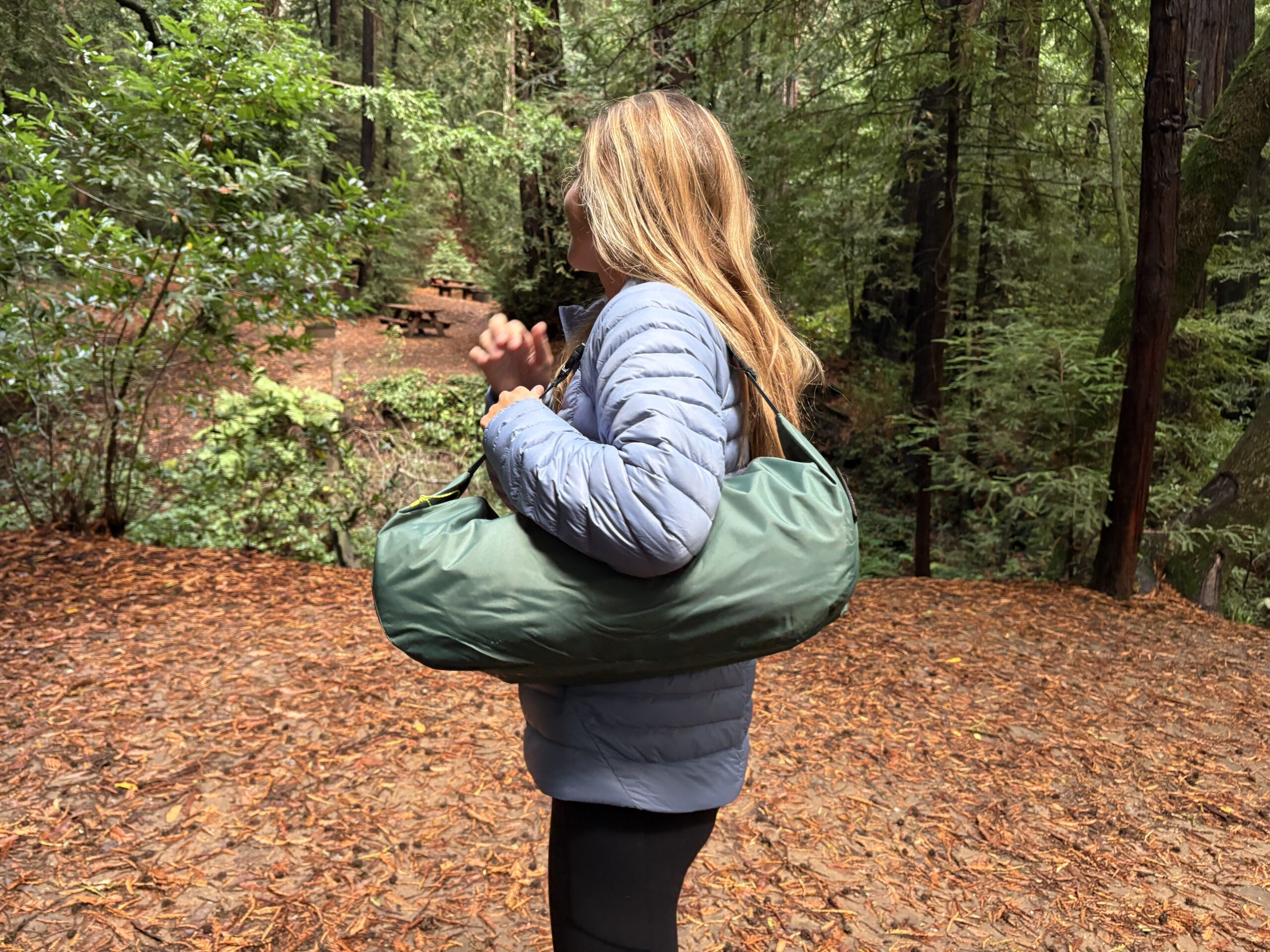 a woman carrying a tent 