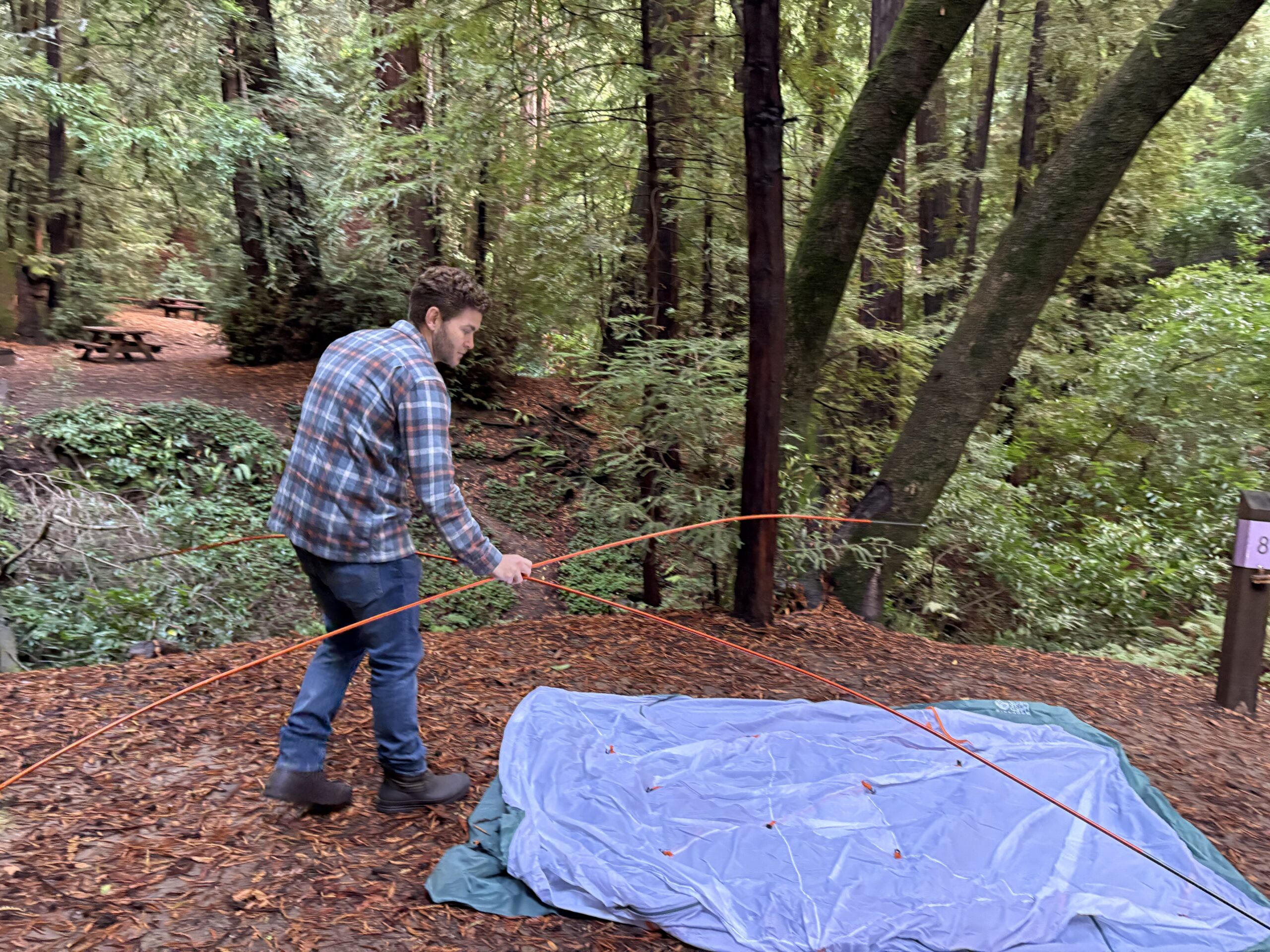 a man putting a tent together 