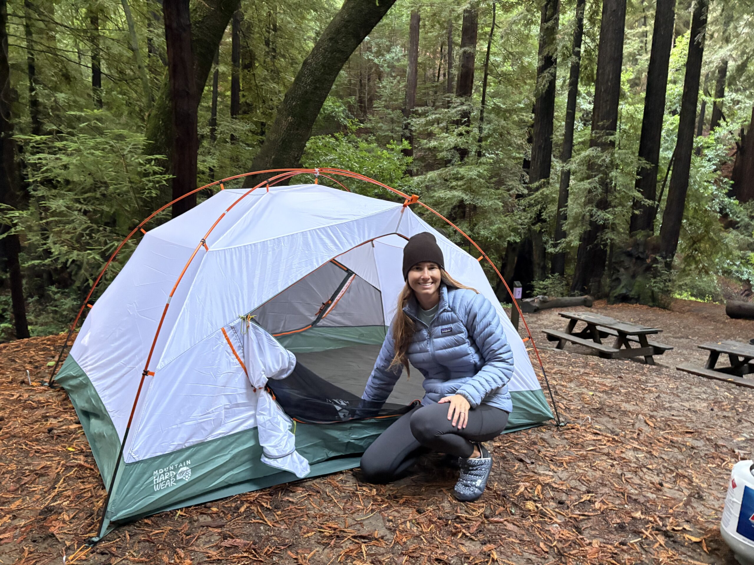a woman in front of a tent 