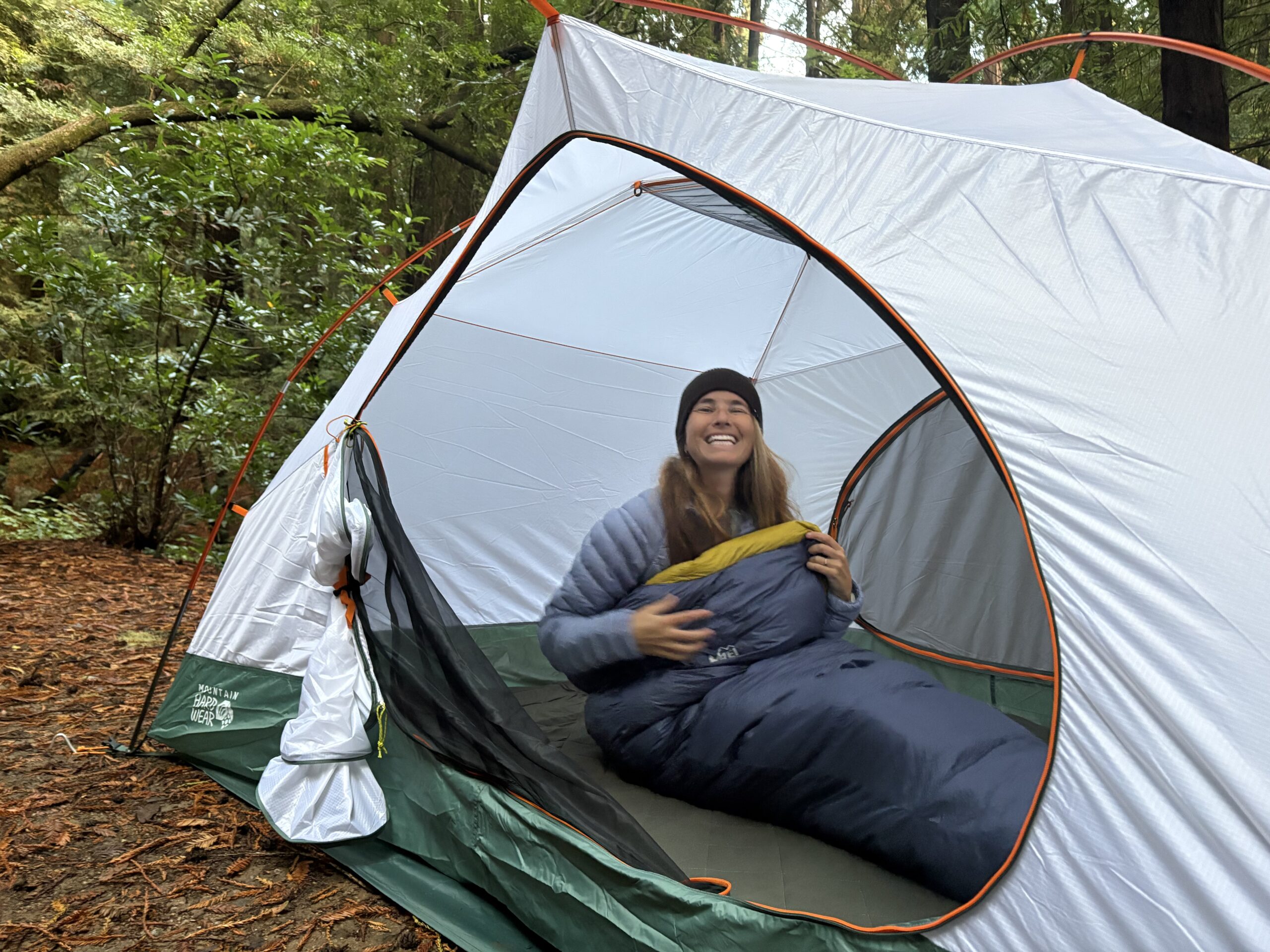 a woman in a tent in a sleeping bag