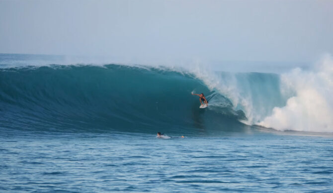 Man surfing on a wave in East Indonesia